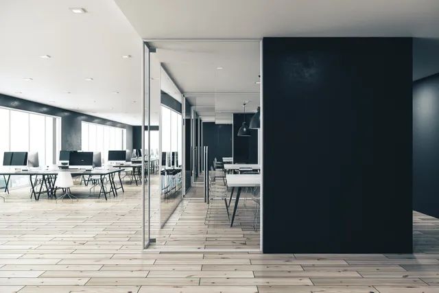 Open plan office repainted out of hours with a dark feature wall